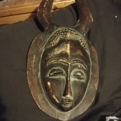 A carved wooden mask with horns.