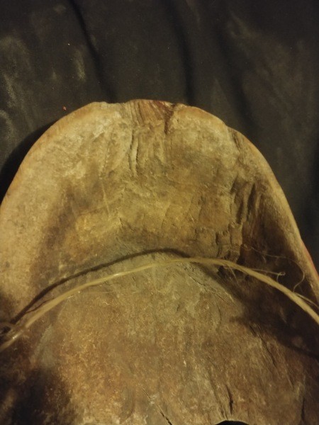 The underside of a carved wooden mask.