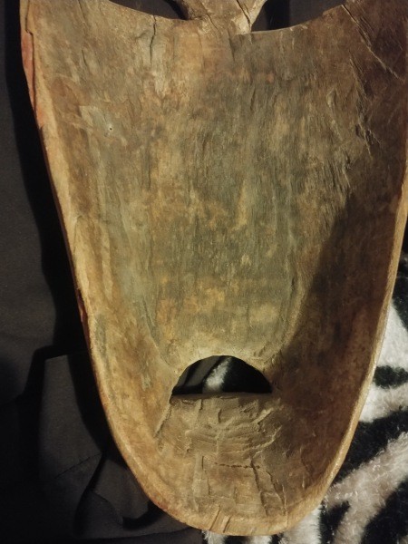 The underside of a carved wooden mask.