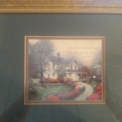 A Thomas Kinkade framed print of a White House and gardens.