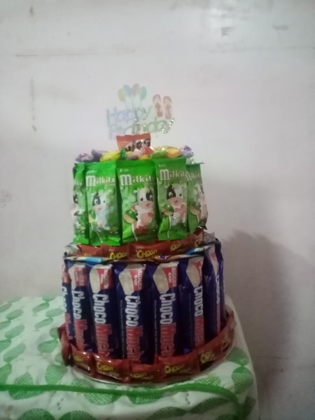 Adding candy to the outside of the cake.