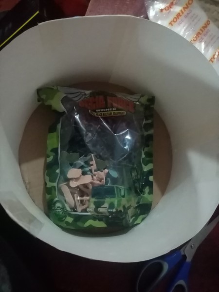 Placing a bag of toys in the bottom.