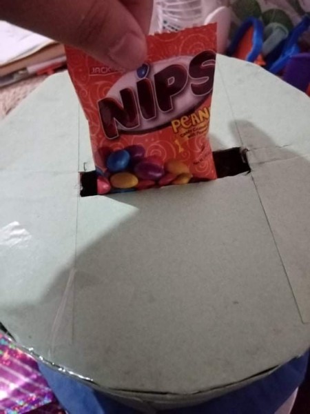 Placing candy through the slot.