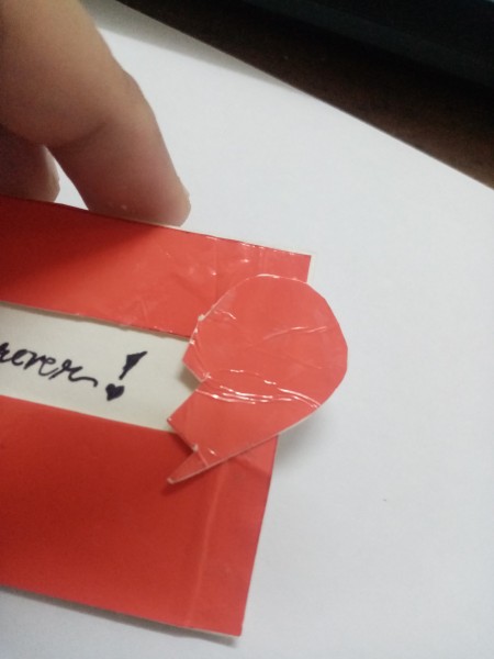 The broken heart being placed as a pull tab for the card.