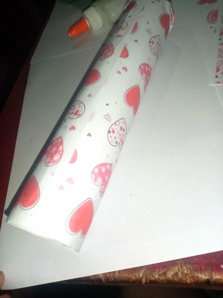 A roll of paper with decorative hearts.