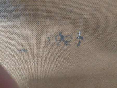 Markings on the back of a dresser.