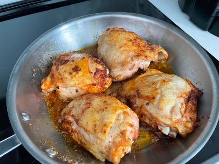 Cooking the chicken in a pan.