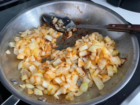 Cooking the onions in a pan.