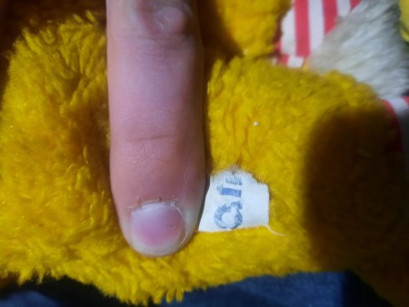 The tag on the back of a stuffed bunny.
