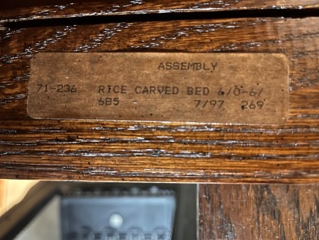 A label on a wooden bed.