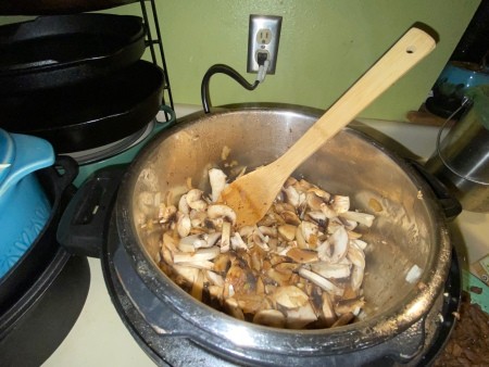 Sautéing mushrooms in the pot.