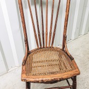 An old wooden chair with a rattan seat.