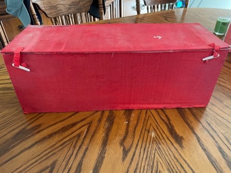 A red box containing a vase.