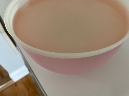 A bowl of lentils soaking in water.