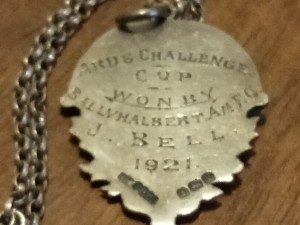 A silver football medal from 1921
