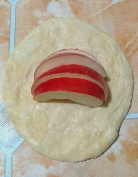 Adding apples to the center of the dough.