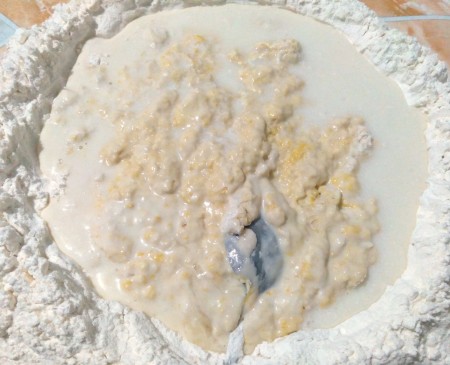 Adding yeast to the flour mixture.