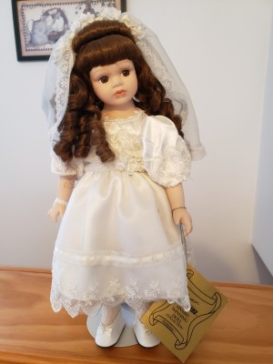 A doll in a white dress and veil.