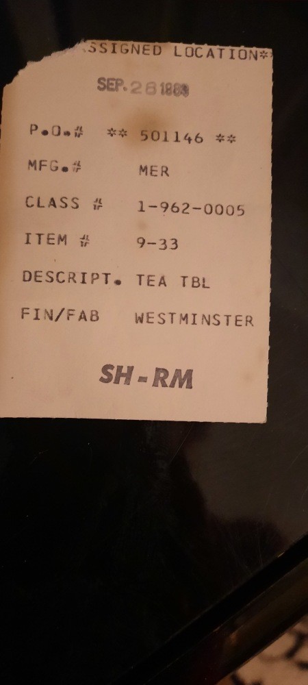 A tag on the underside of a piece of furniture.