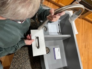 A grey sink next to a white drawer.