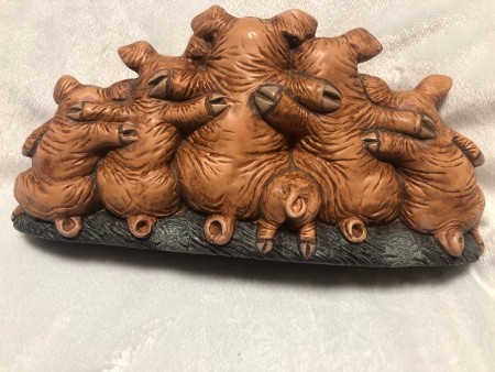 The back of a pig family figurine.