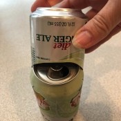 Placing the cut can over the full can.