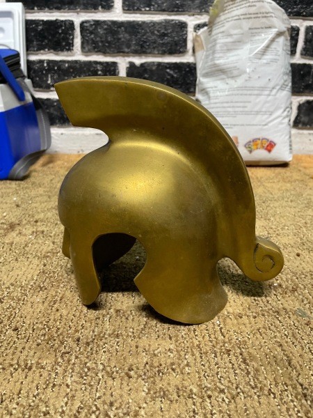 A small decorative metallic helmet.