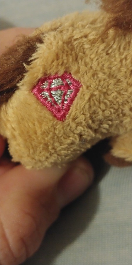 A pink diamond on a stuffed horse.