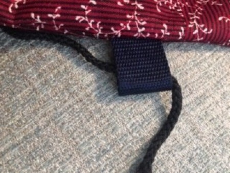 Running the straps through the guide tab.