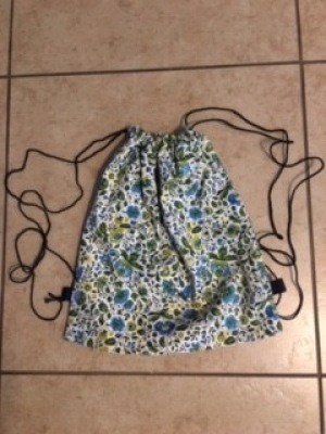 A fabric drawstring backpack.