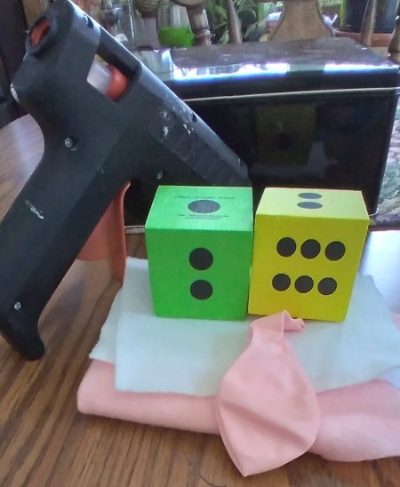 Foam dice, balloons, felt and a glue gun.