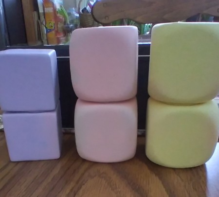 Foam dice covered with balloons in different colors.