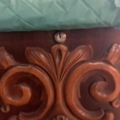 The keyhole in an old cedar chest.