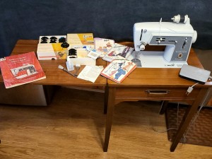 A sewing machine in a cabinet.