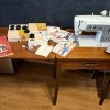A sewing machine in a cabinet.