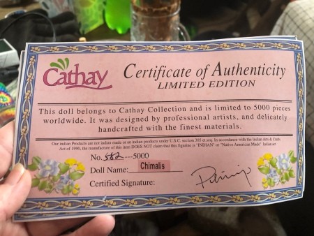 A certificate of authenticity for a porcelain doll.