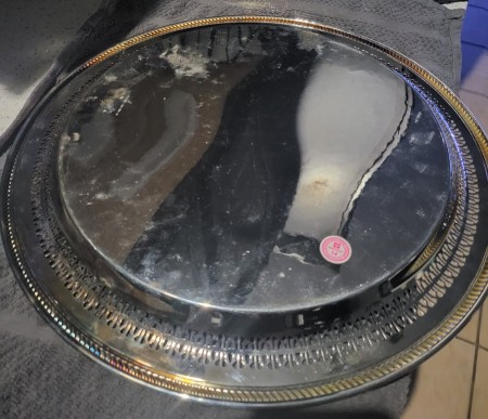The bottom of a silver serving tray.