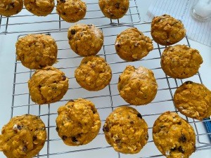 A cooling rack full of baked muffins.