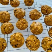 A cooling rack full of baked muffins.