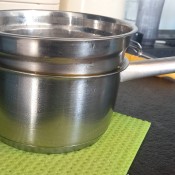 A bowl stuck in a stainless steel saucepan.