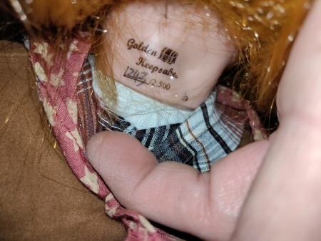 The information on the back of the doll's neck.