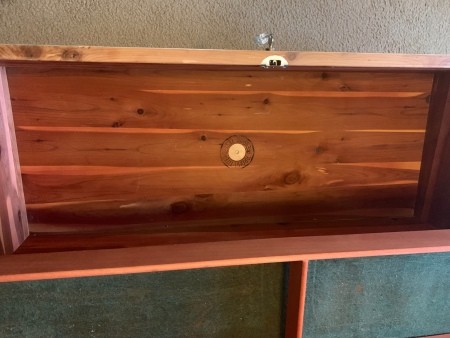 Inside the lid of a cedar chest.