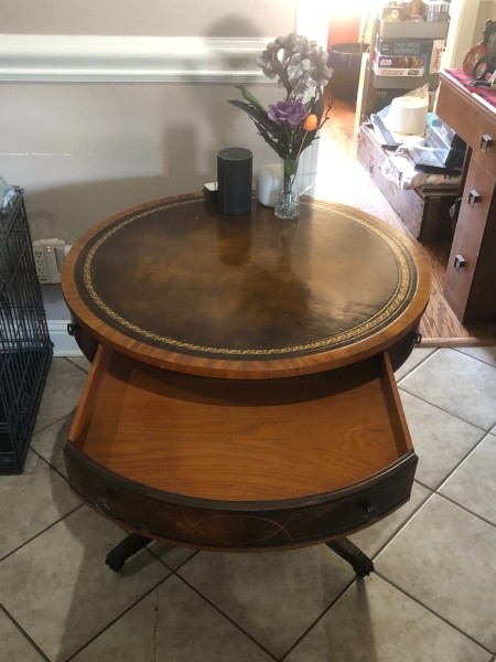 A table with a drawer pulled out.