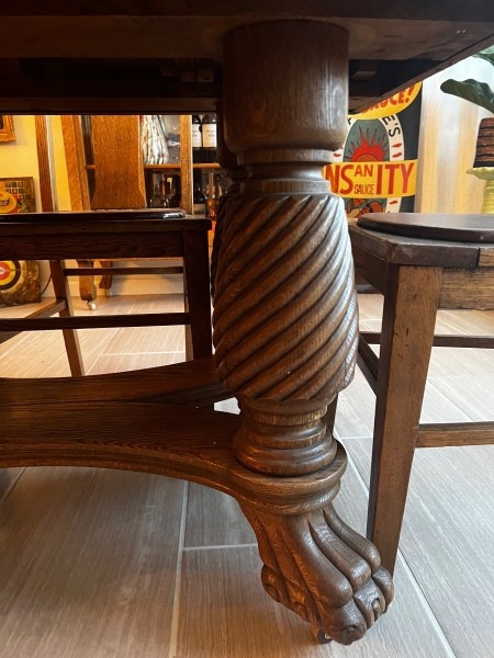 The legs of an antique oak dining table.