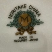 The marking on the back of a set of china.