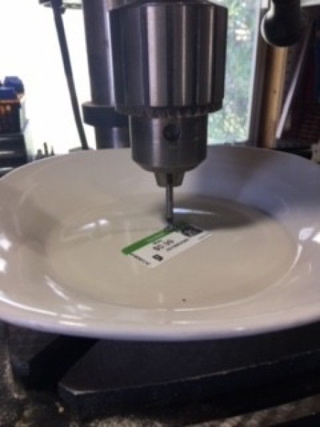 Drilling a hole in a ceramic plate.
