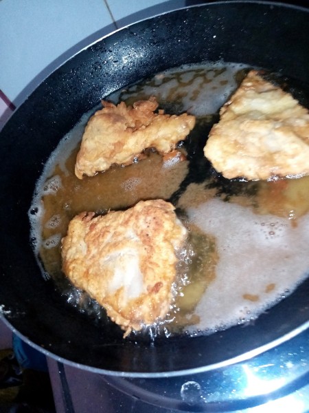 Frying the coated egg sections.