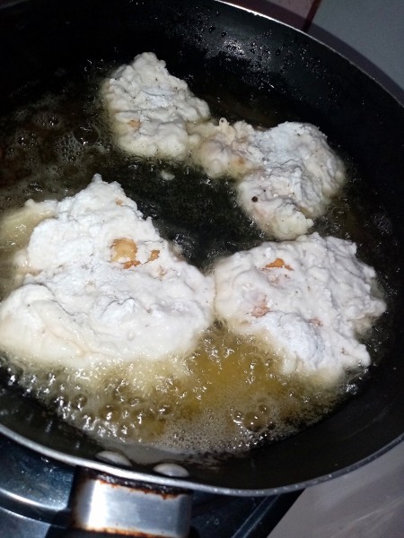 Frying the coated egg sections.