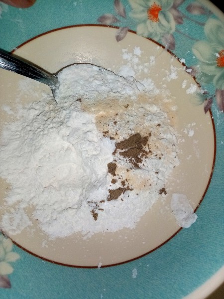 Mixing together the flour coating for the eggs.