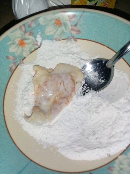 Coating the eggs with the flour mixture.